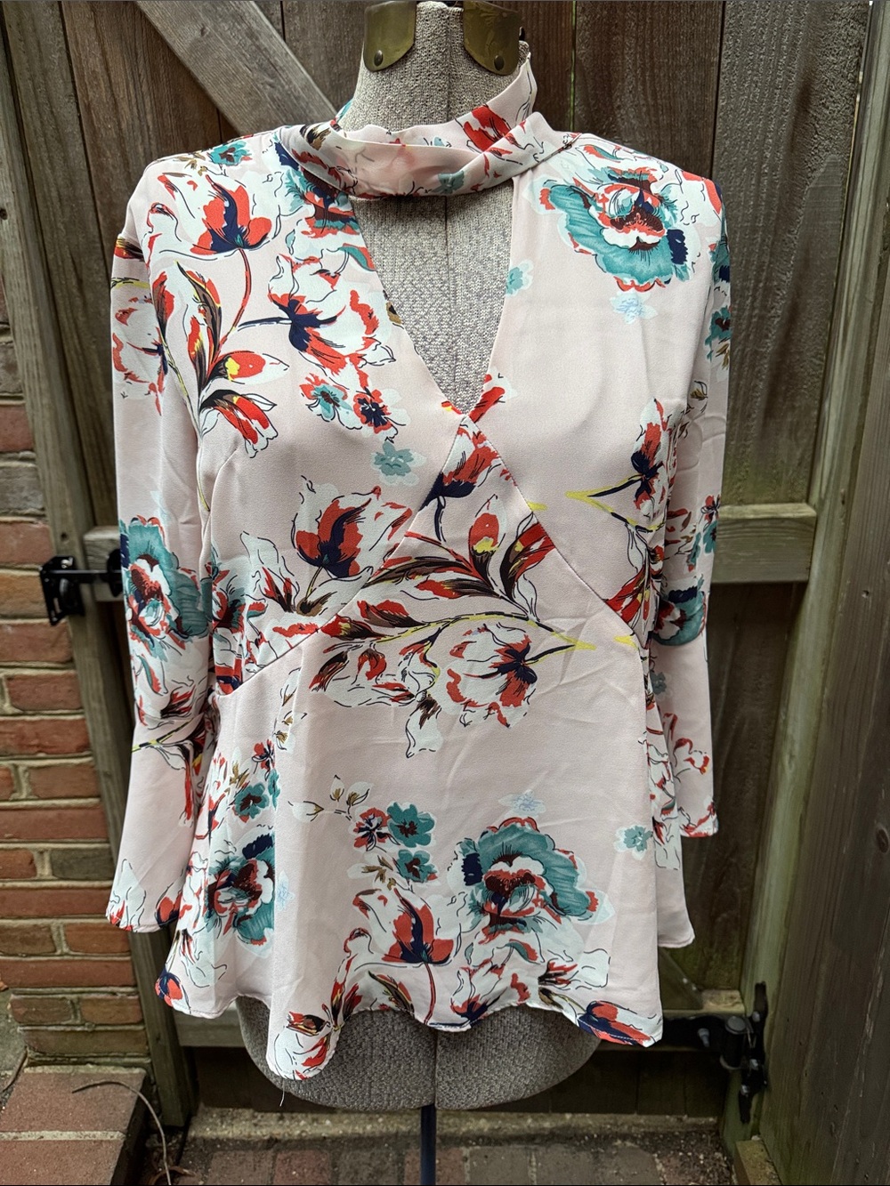 Bebe Floral Blouse with floral Blush, Teal, and rust pattern and neck tie